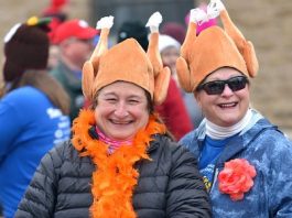 Two women wearing silly turkey hats