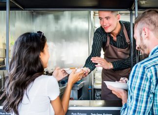 boy serving food from food truck